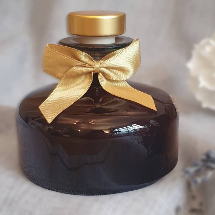 Luxury amber glass fragrance diffuser with sola wood flower